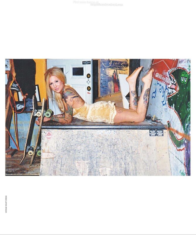 tattooed woman on skateboard ramp