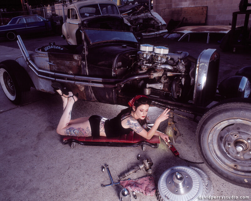Tattooed Woman under Car