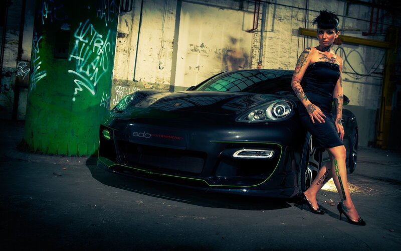 Tattooed woman with black car