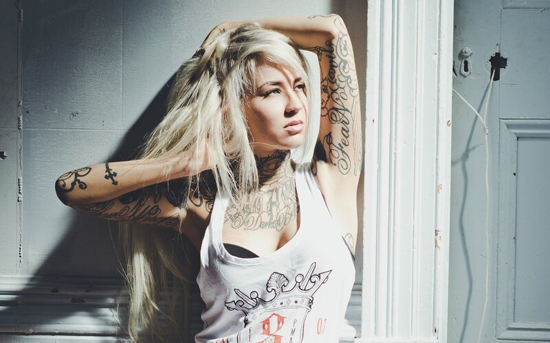 tattooed woman with blonde hair