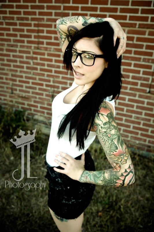tattooed woman with glasses