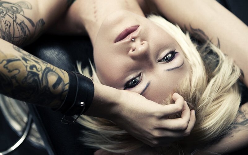 tattooed woman with nose piercing
