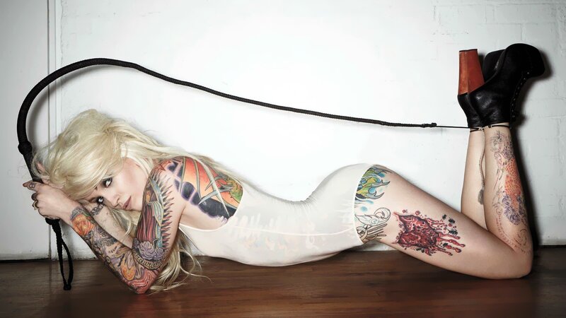 tattooed woman with whip