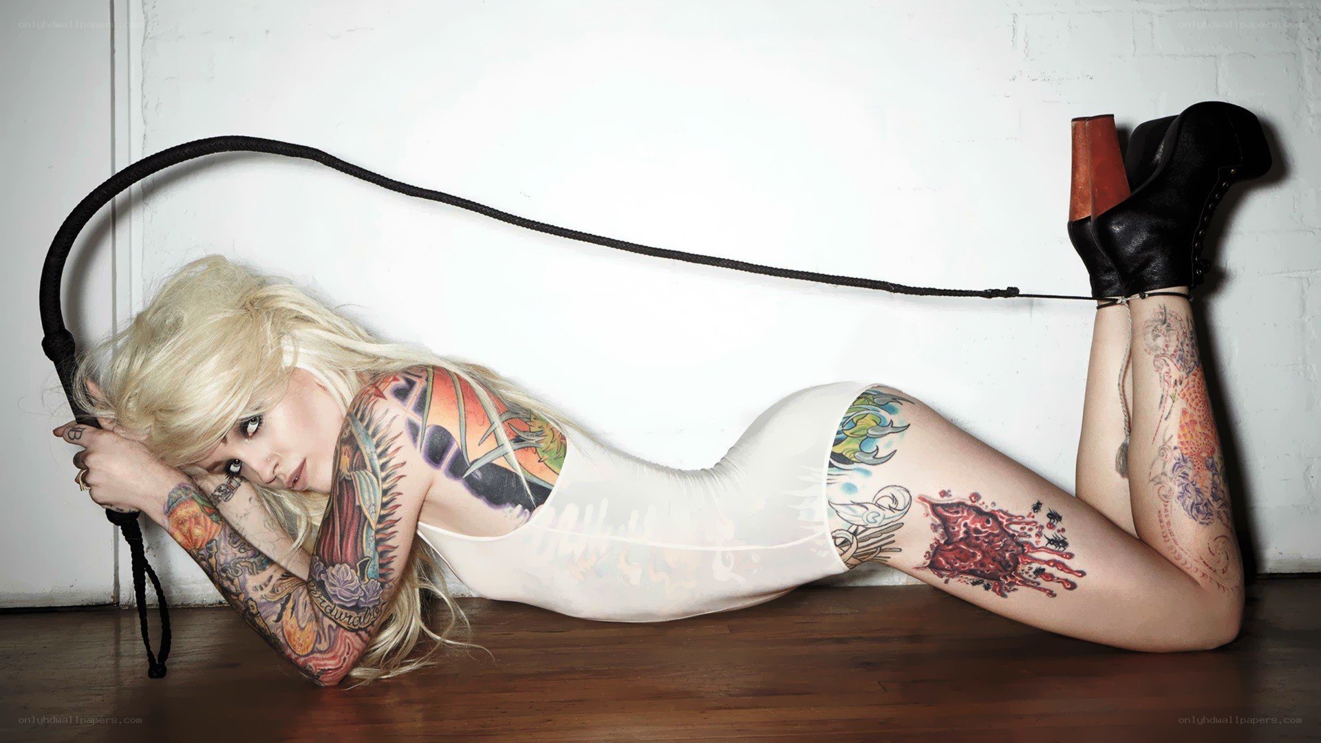 tattooed woman with whip