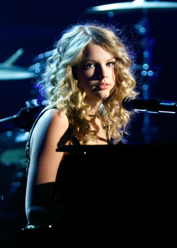 Taylor Swift at piano on stage