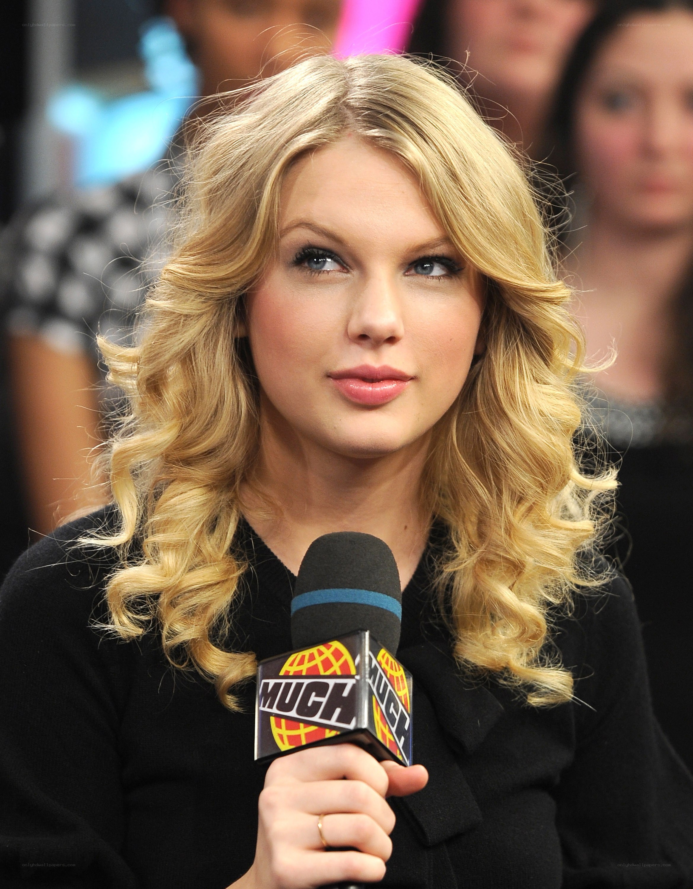 Taylor Swift holding a microphone