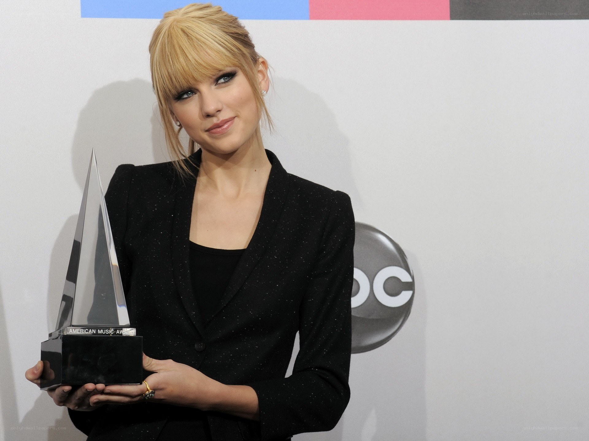 Taylor Swift holding award