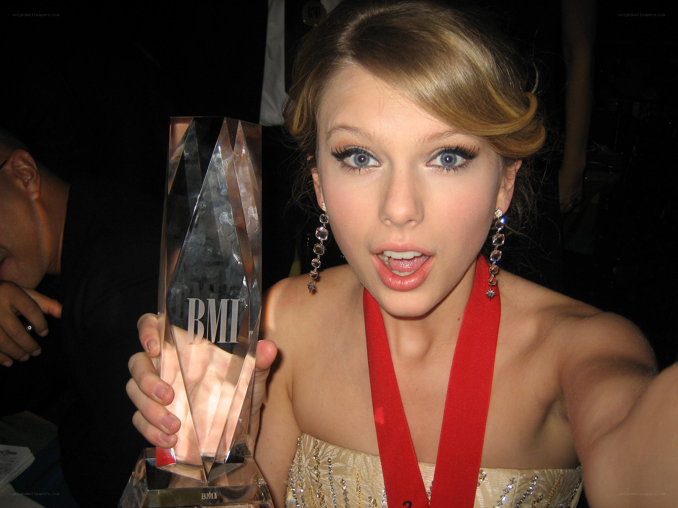 Taylor Swift holding BMI award