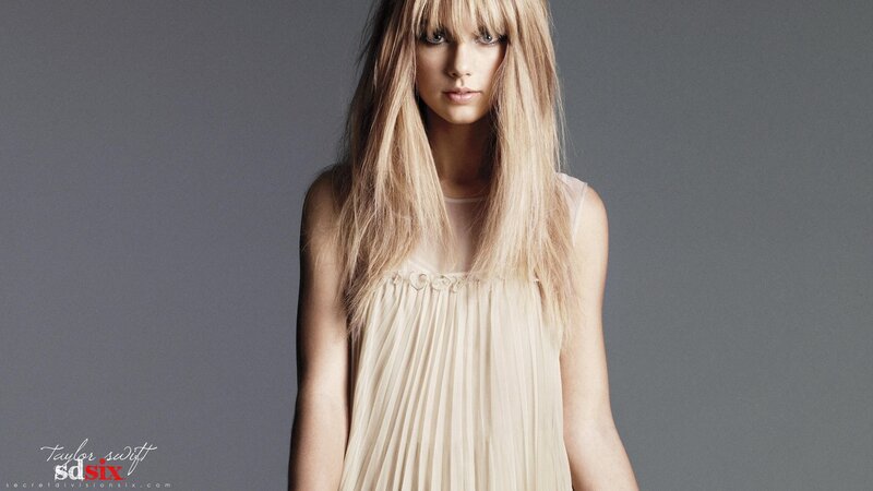 Taylor Swift in a beige dress