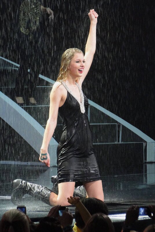 Taylor Swift on stage in rain