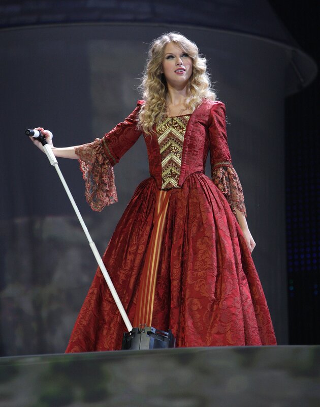 Taylor Swift on stage in red gown