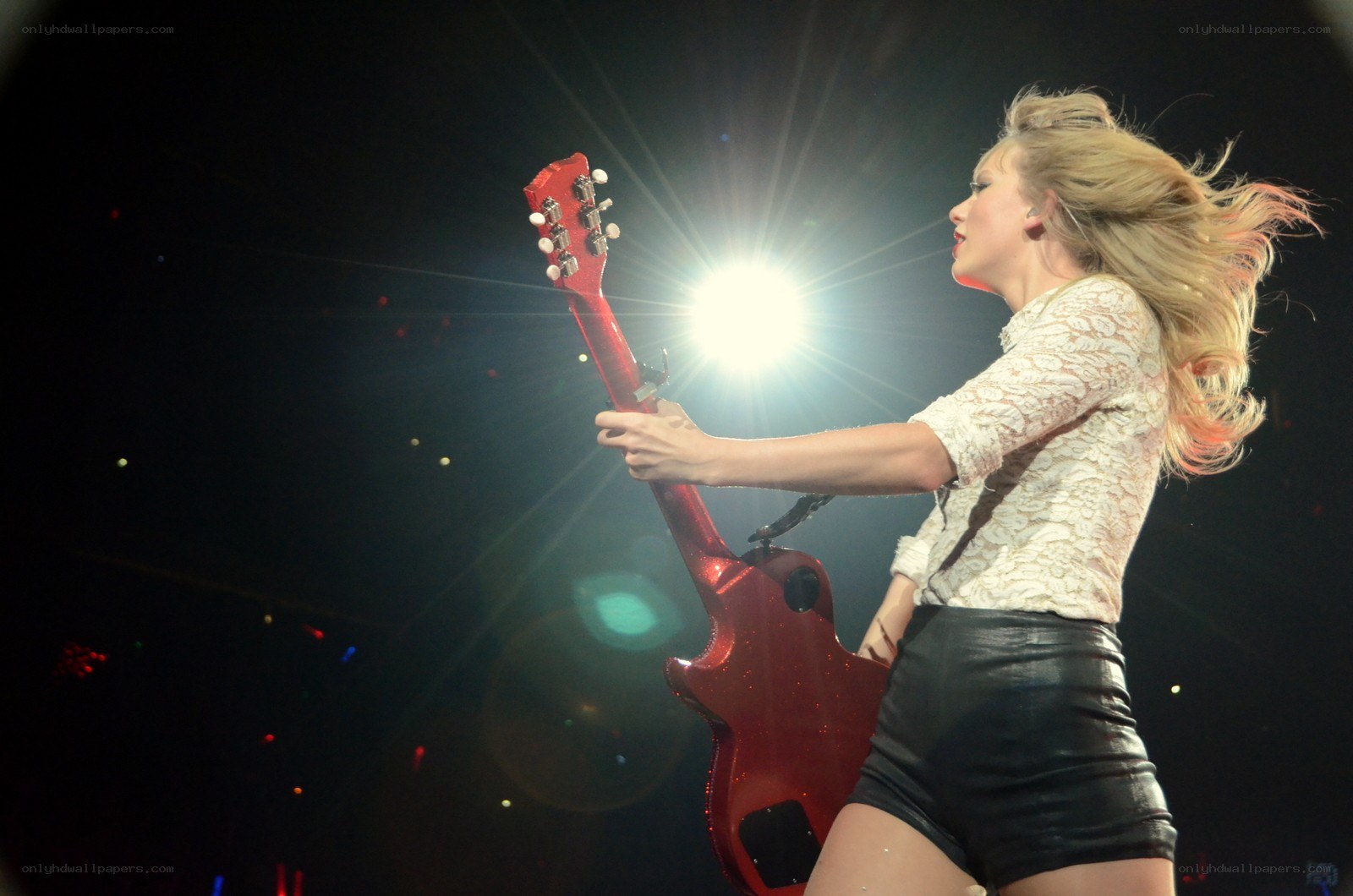Taylor Swift on stage with guitar