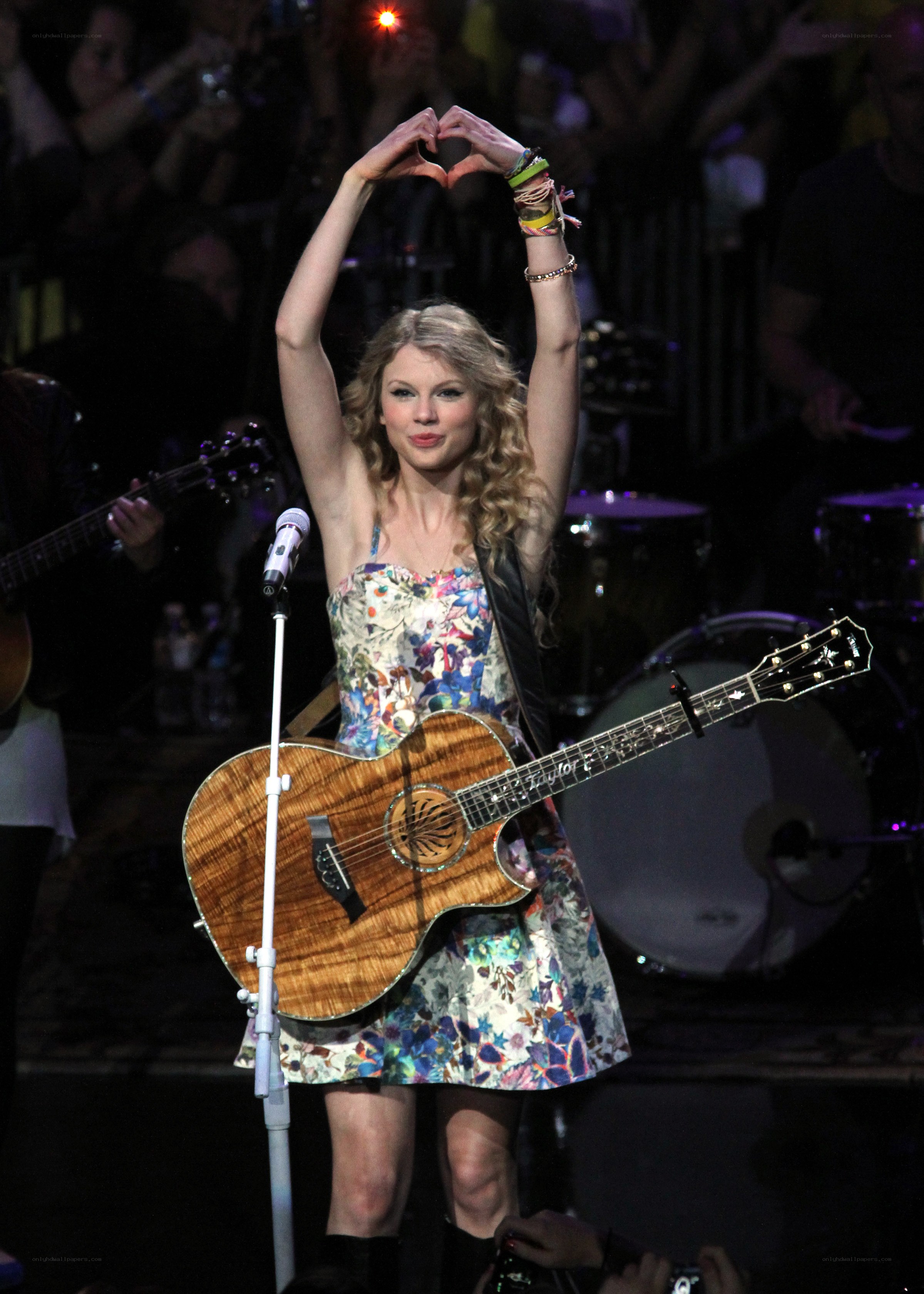 Taylor Swift on stage with guitar