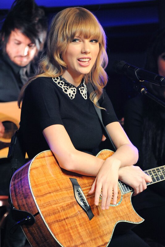 Taylor Swift performing with guitar