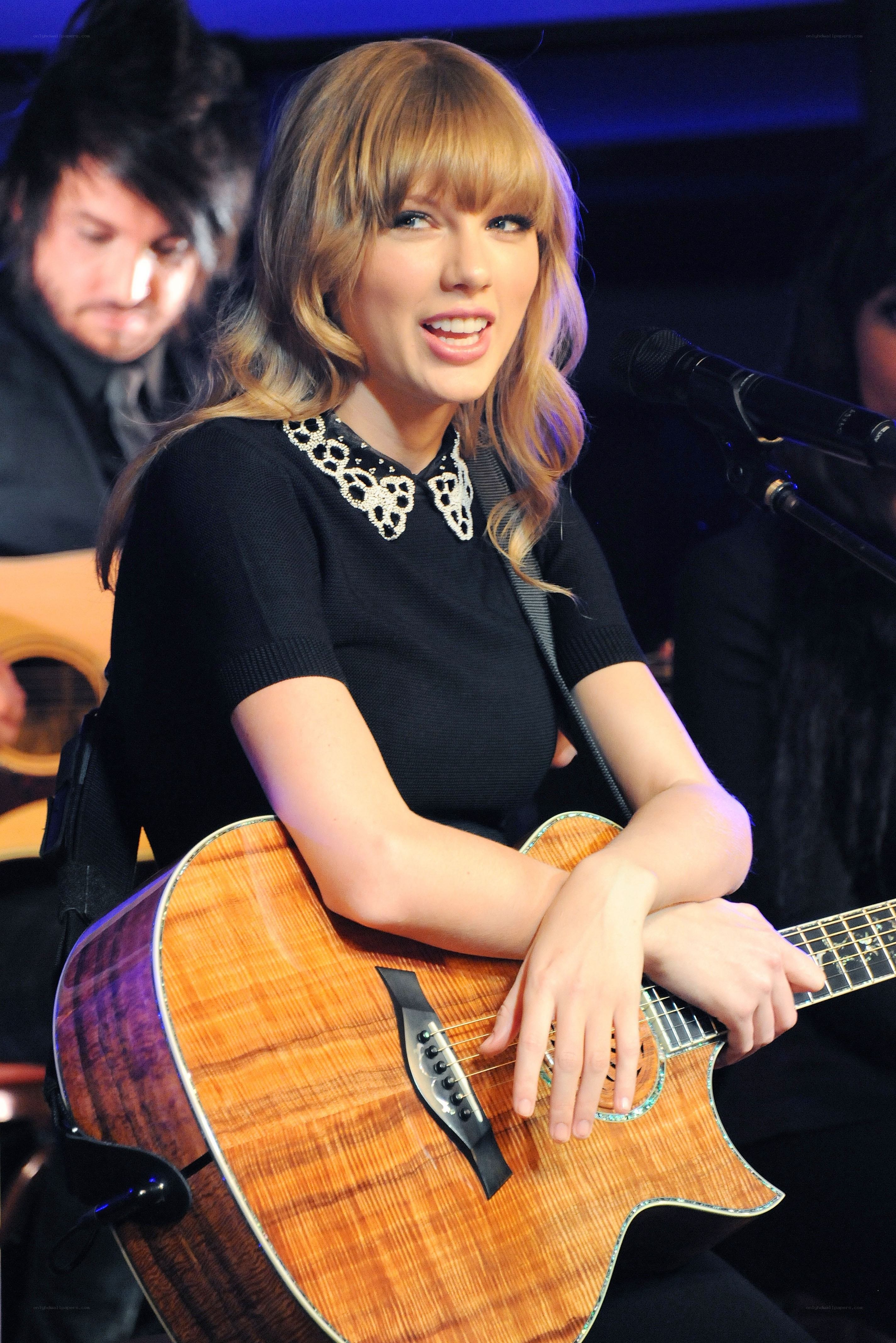 Taylor Swift performing with guitar