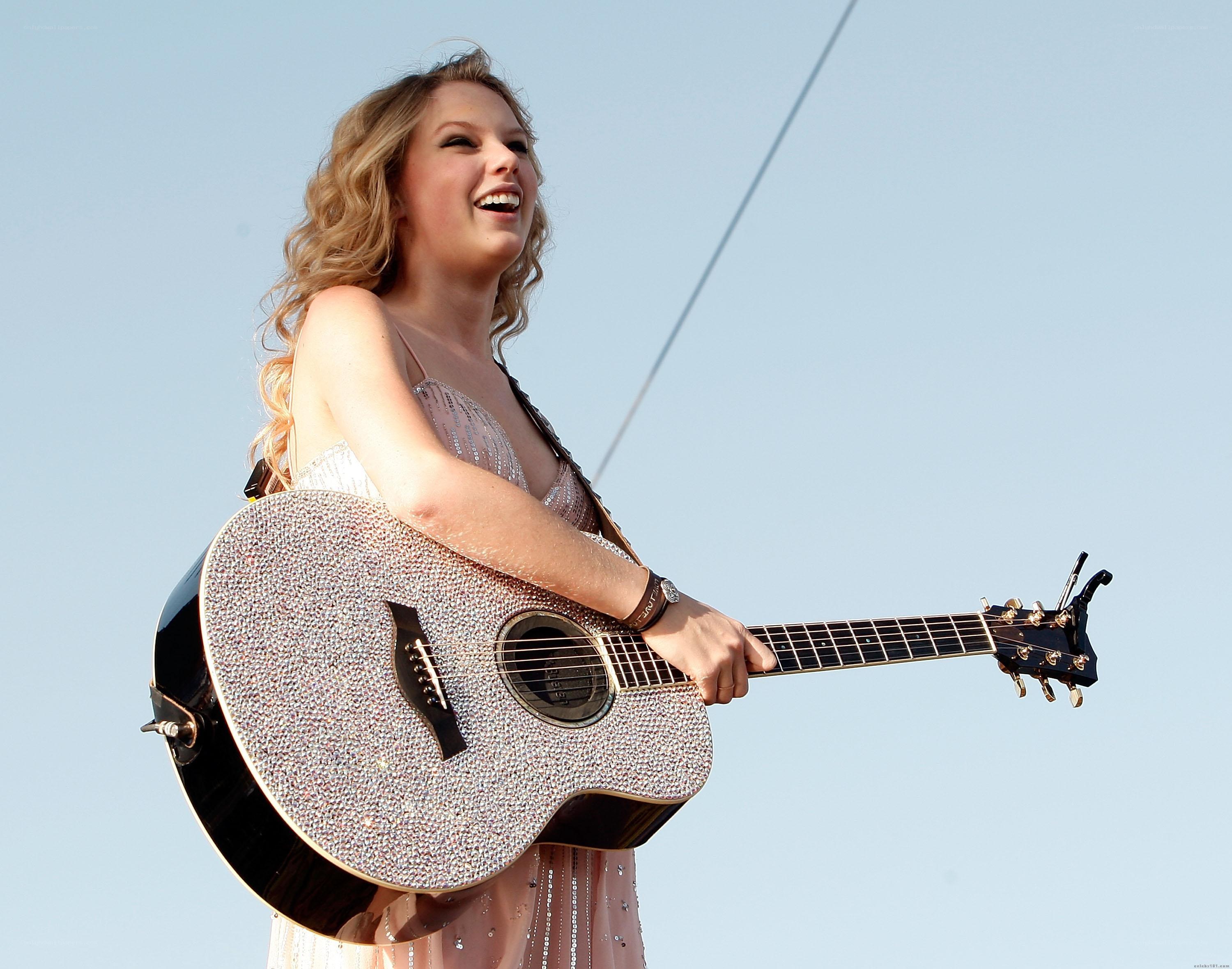 Taylor Swift performing with guitar