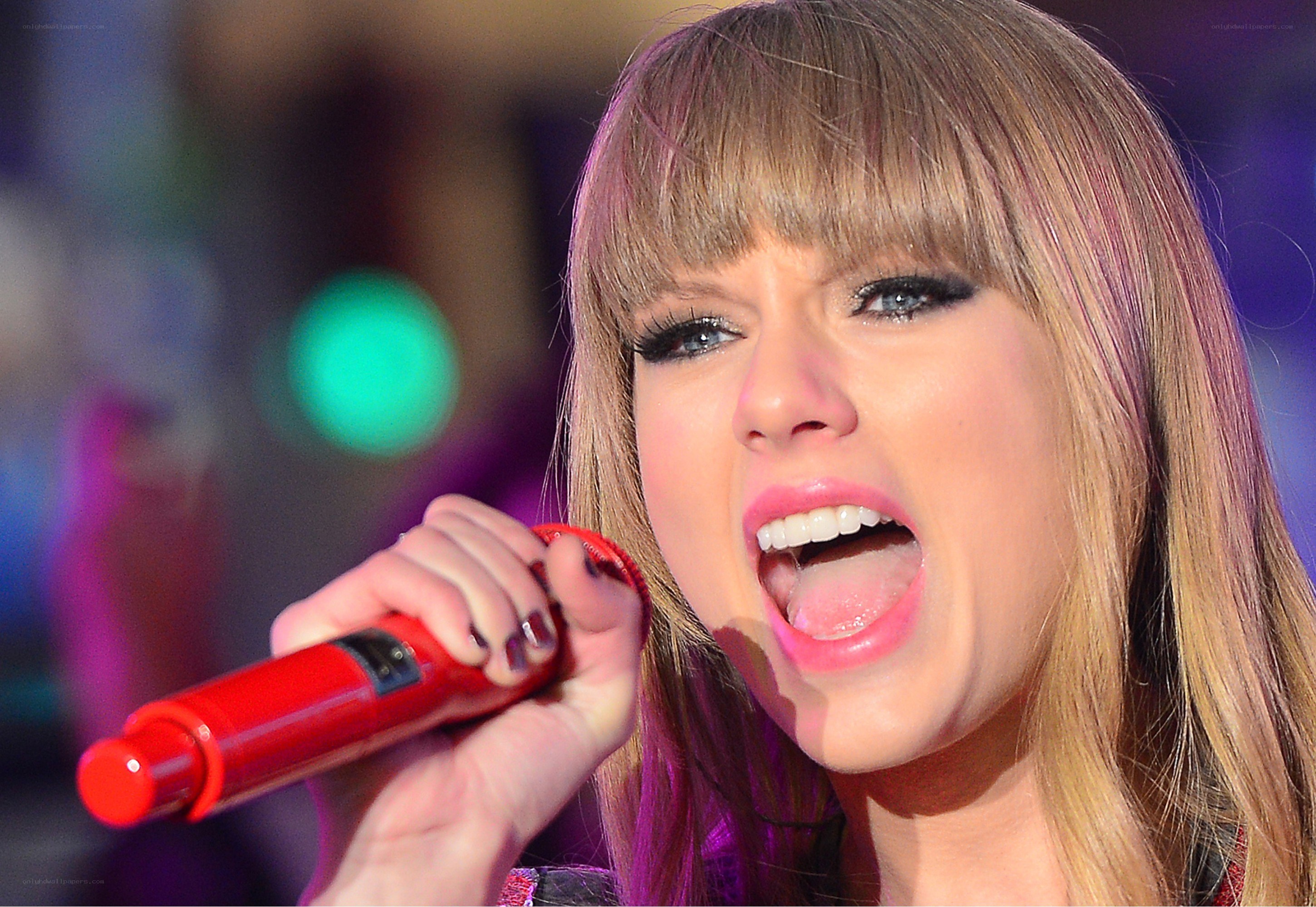 Taylor Swift singing into a microphone