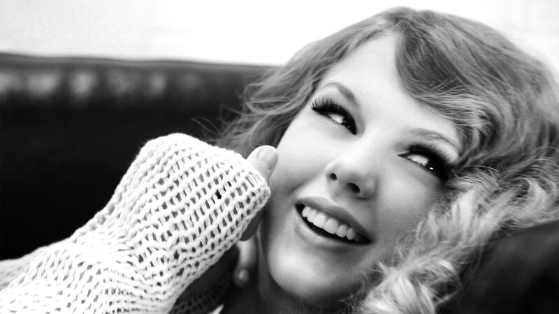 Taylor Swift smiling in black and white