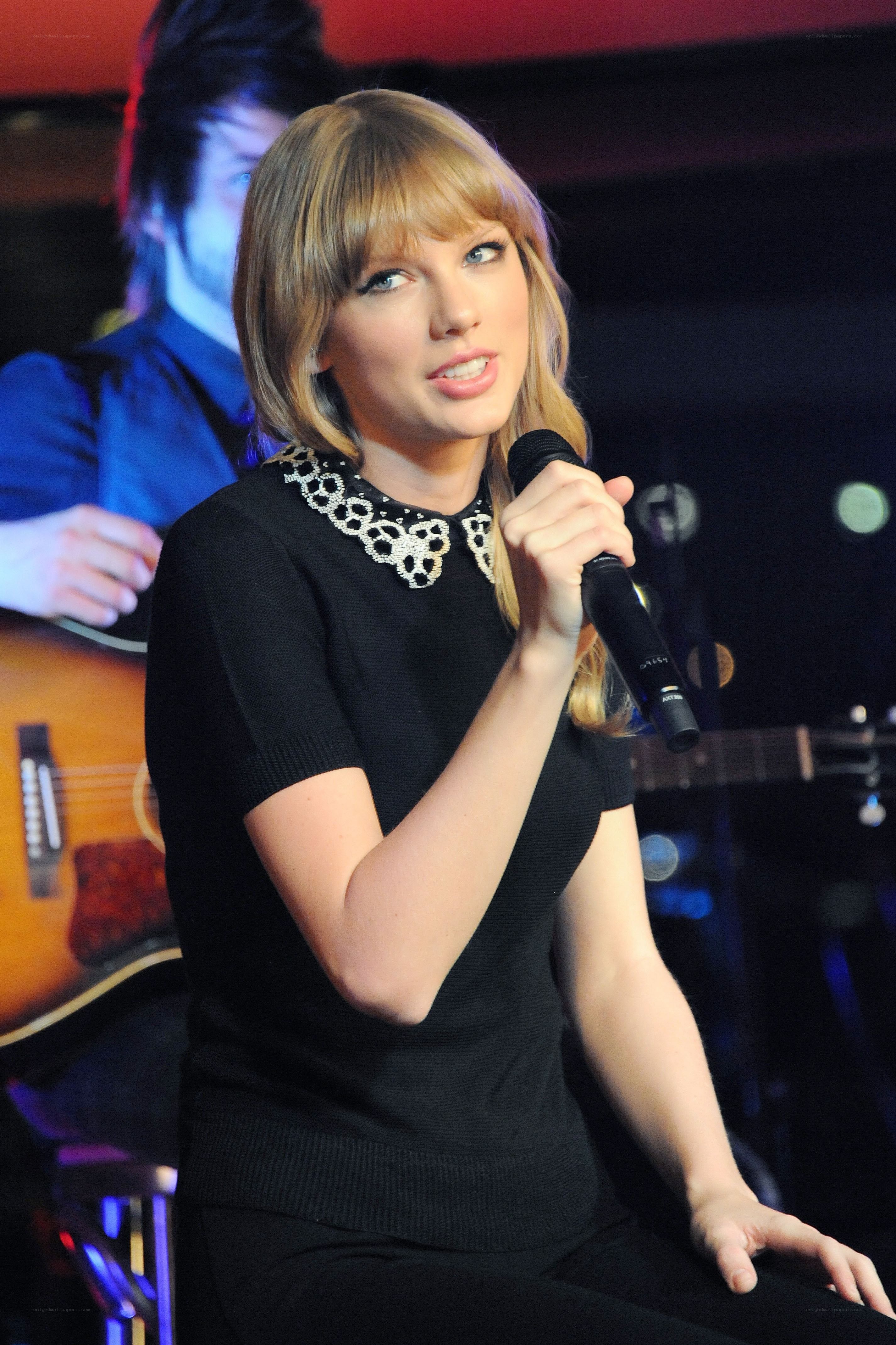 Taylor Swift speaking into a microphone