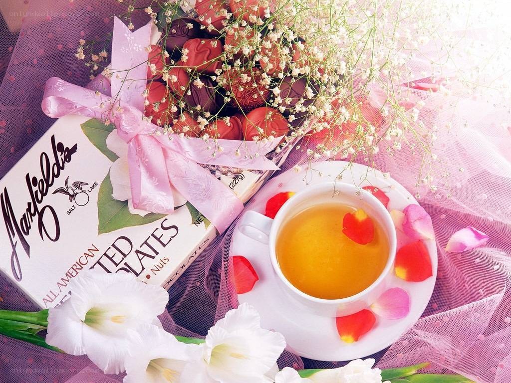 Tea and chocolates with flowers