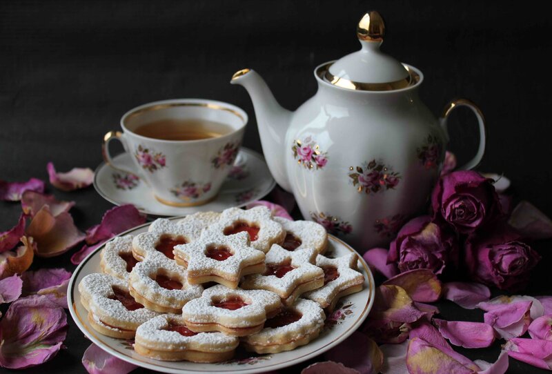 Tea and cookies with rose petals