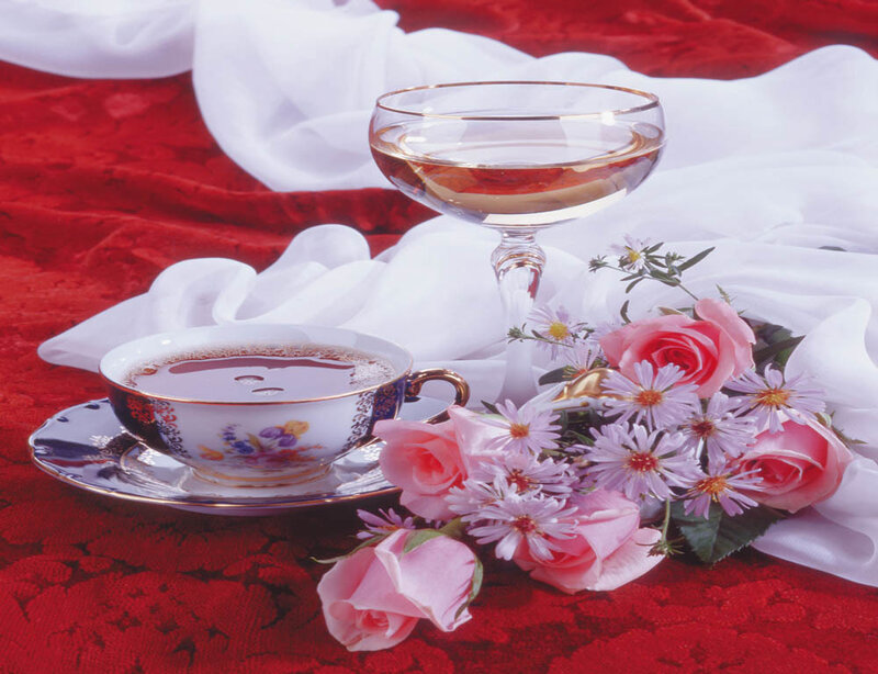 Tea and flowers on red cloth