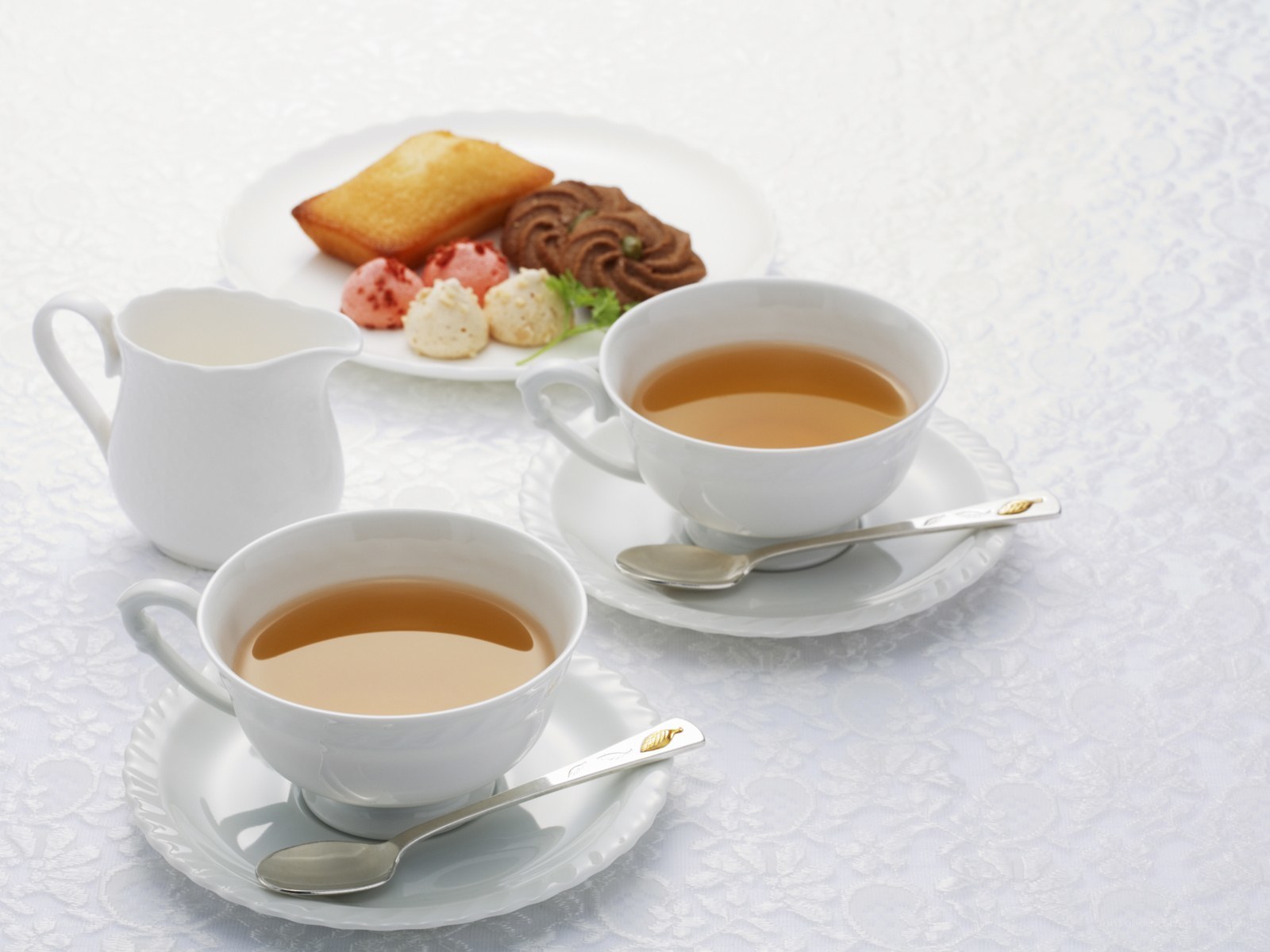 Tea and pastries on white table