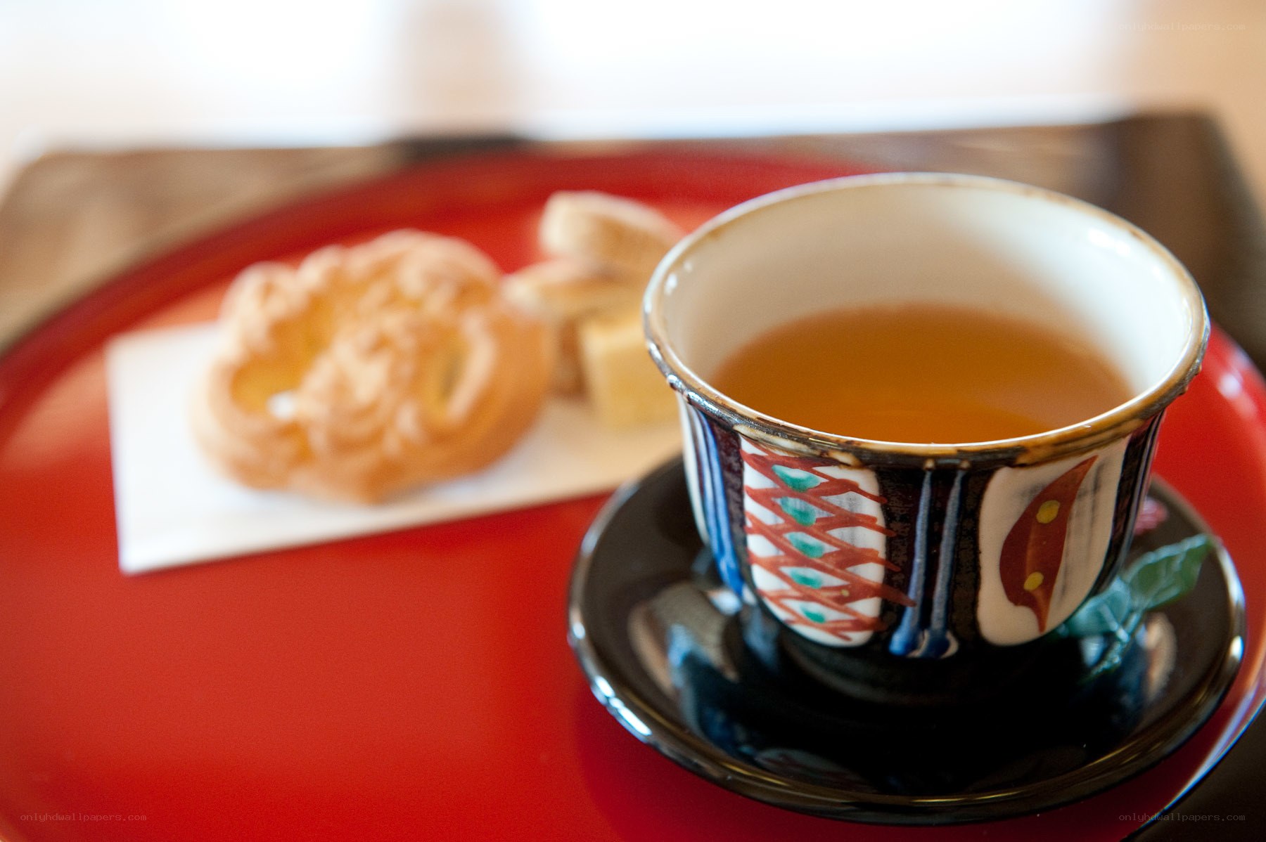 Tea and pastry on a red tray