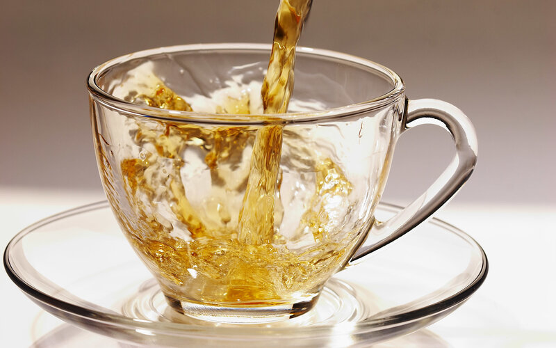 tea being poured into a cup