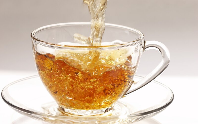 tea being poured into a cup