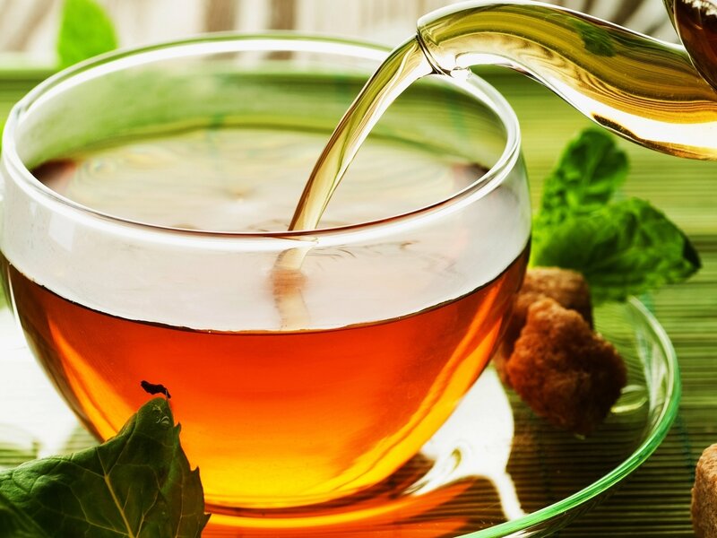 tea being poured into a cup