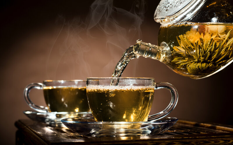 Tea Being Poured into Cup — Brown