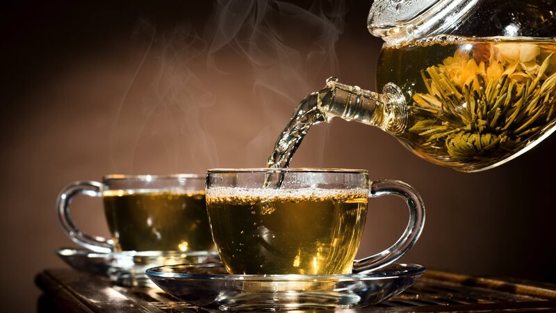 Tea Being Poured into Cups — Brown