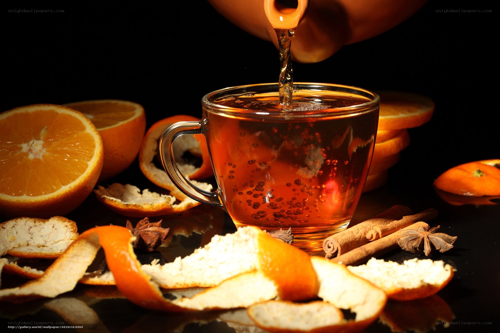 Tea being poured with oranges