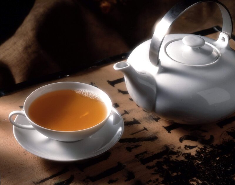 Tea cup and teapot on table