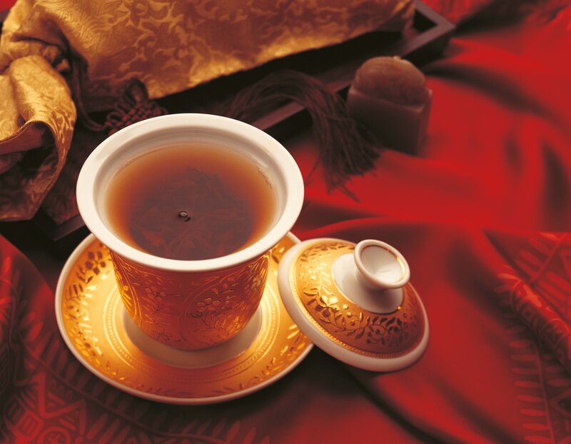 tea cup on red fabric