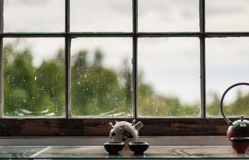 Tea set by a rainy window