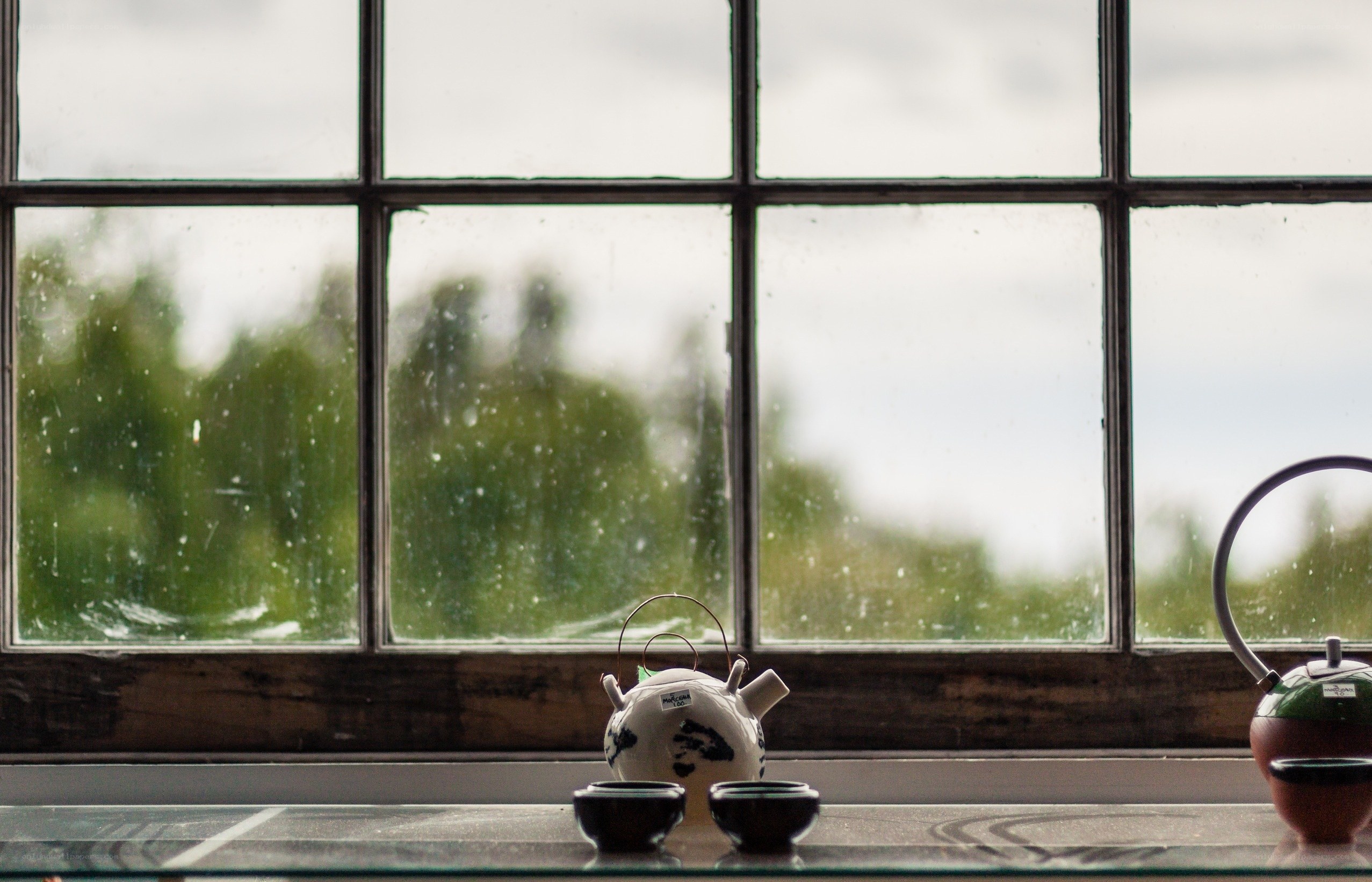 Tea set by a rainy window