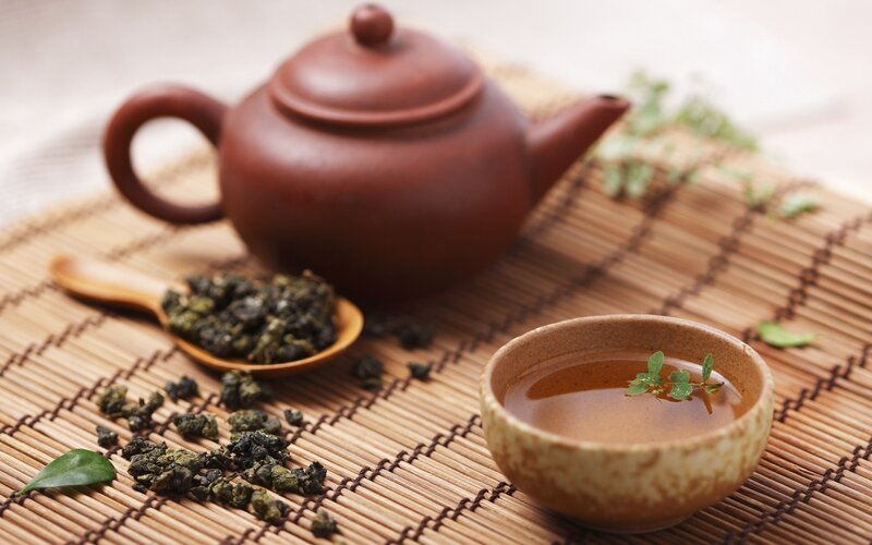 Tea Set on Bamboo Mat — Brown, Serene, Photograph, Teapot, Cup, Spoon, Leaves
