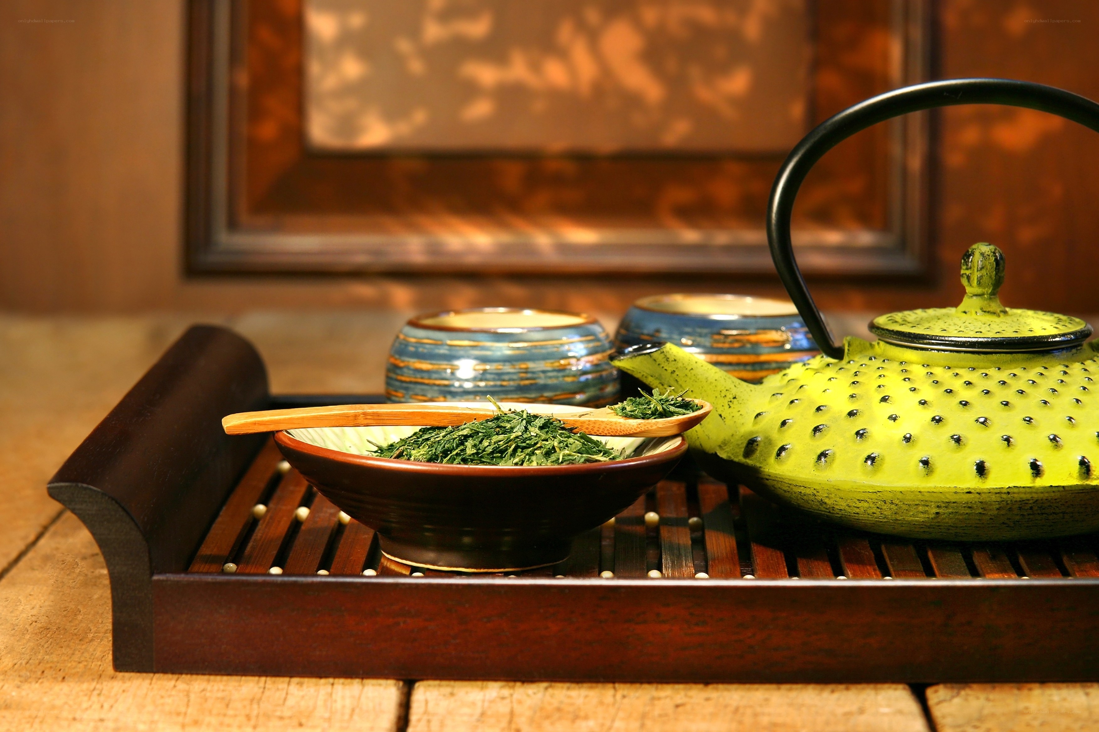 Tea set with green tea leaves