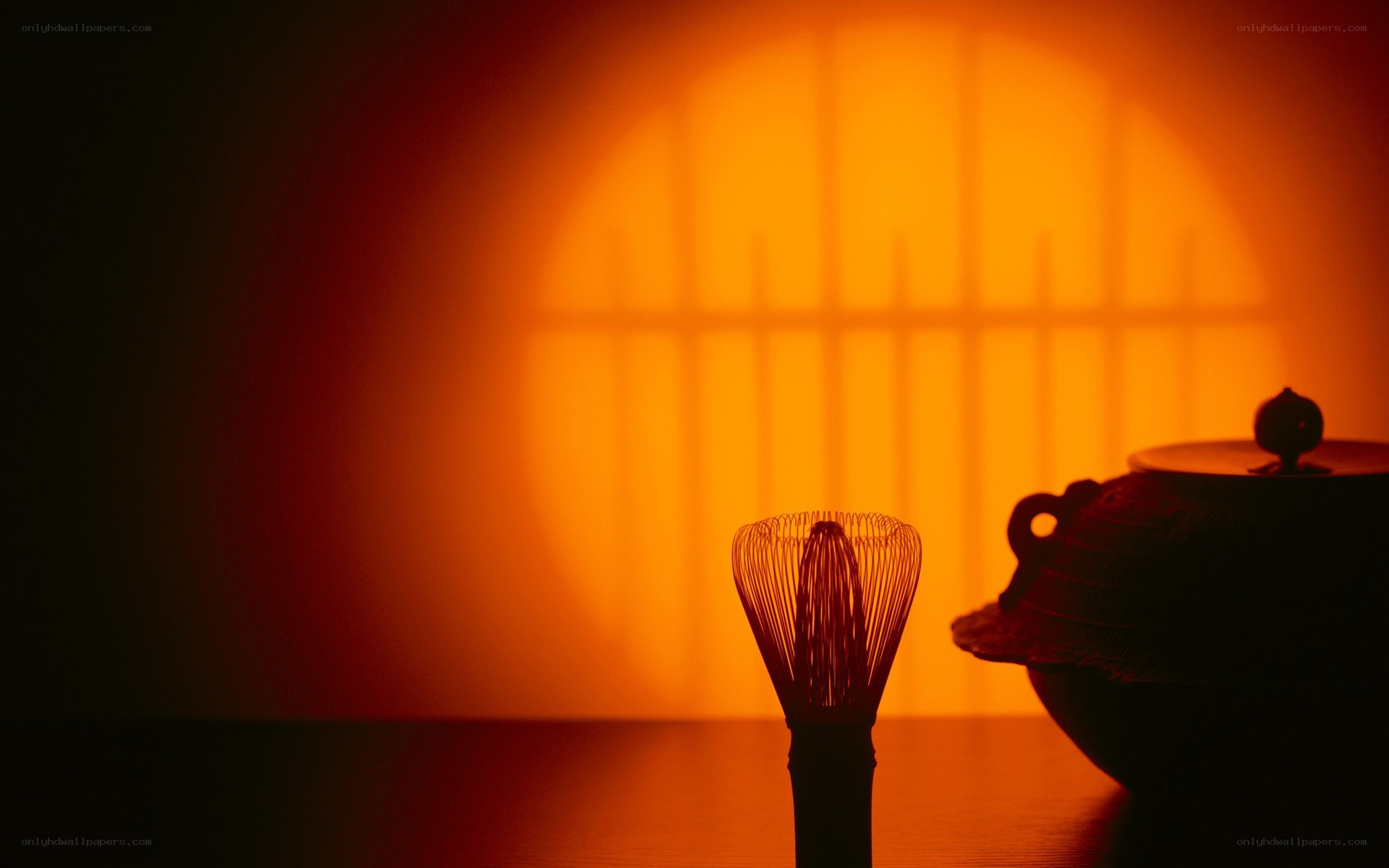 tea whisk and pot in warm light