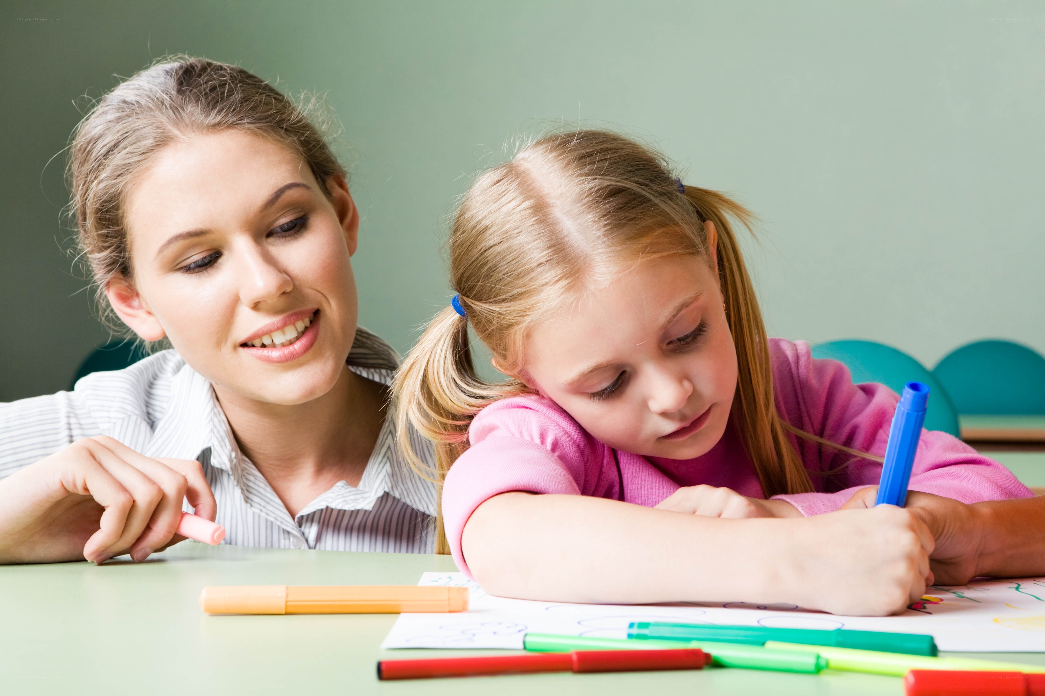 teacher helping student draw