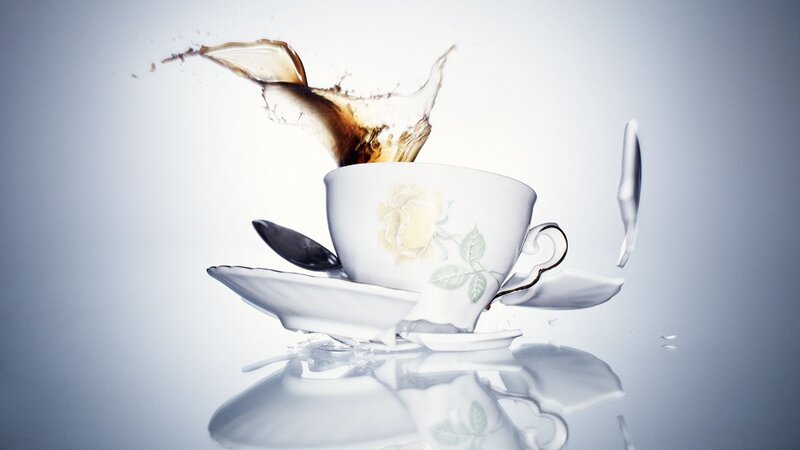 Teacup shattering with tea splash