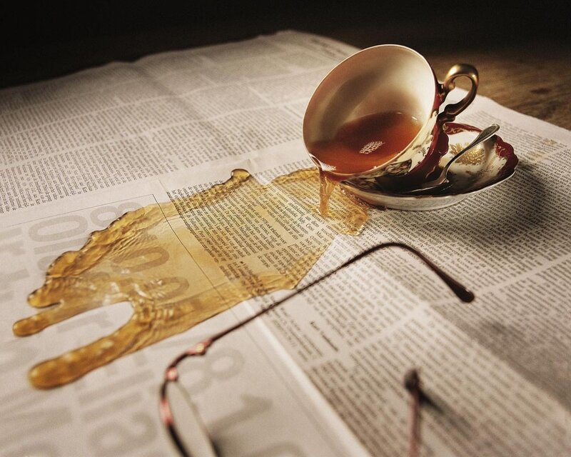 Teacup spill on newspaper