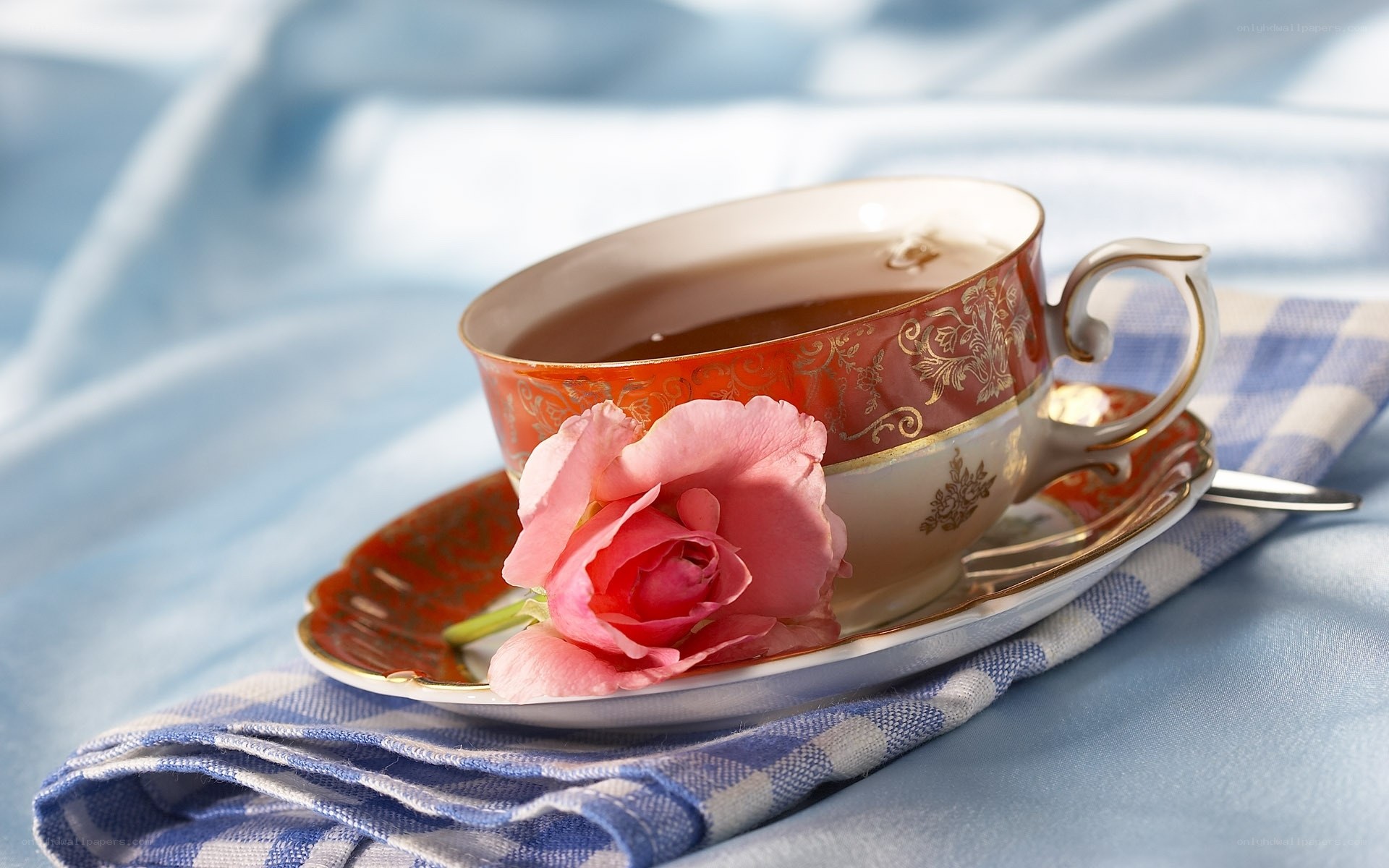 Teacup with rose on napkin