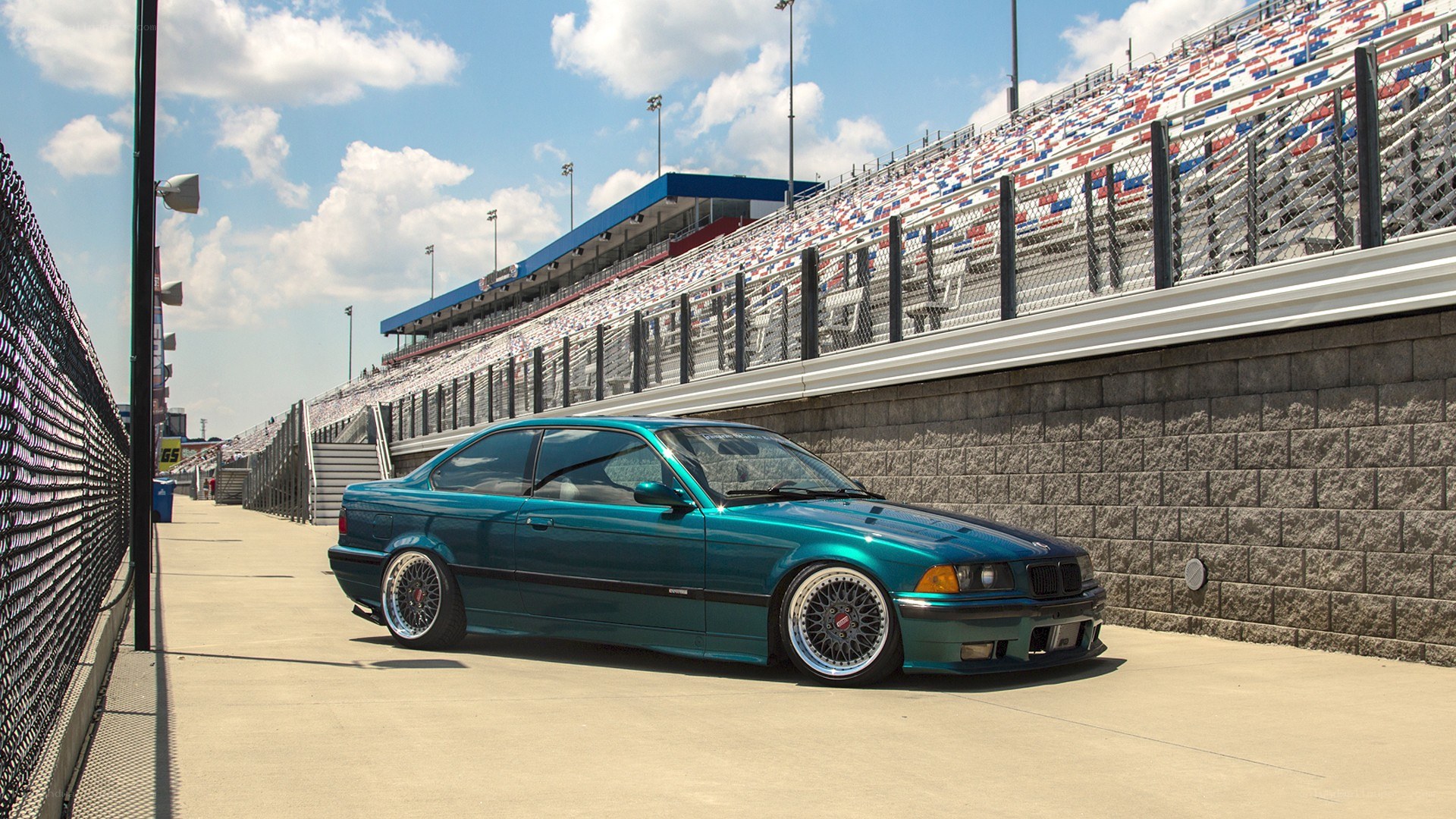 Teal BMW at racetrack