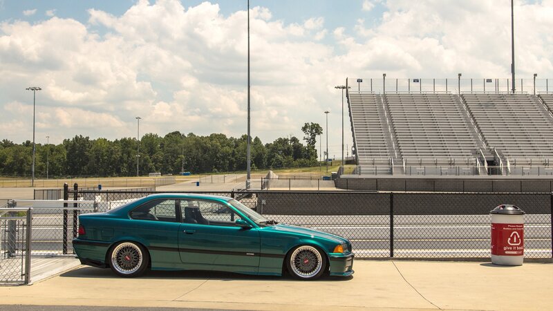 teal car at racetrack