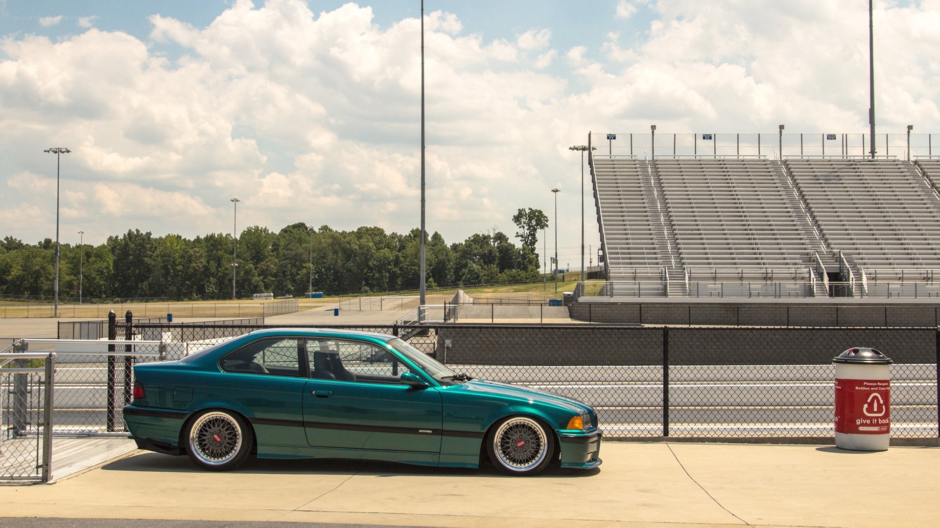 teal car at racetrack