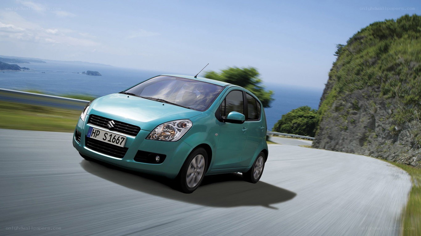 Teal car on coastal road