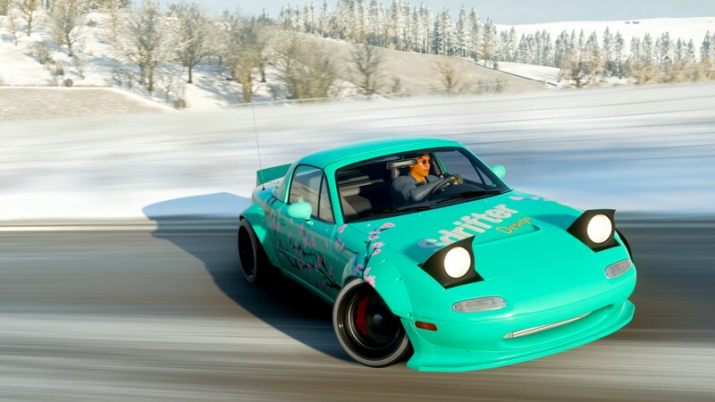 Teal Car on Snowy Road